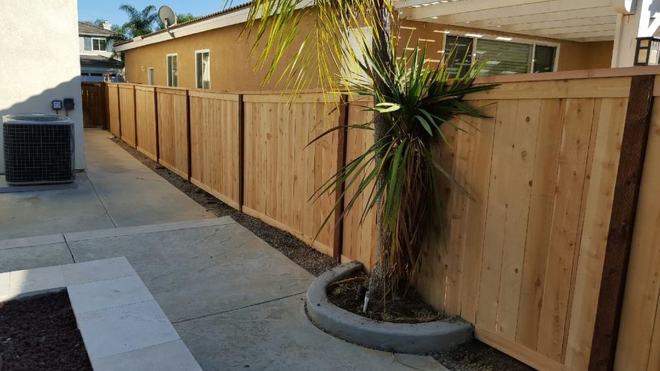 Wood picture-frame fence built along the side of a Valley Center home